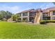 Spacious backyard featuring a patio, screened-in lanai, and well-manicured lawn, perfect for outdoor living at 8103 Bardmoor Pl # 203G, Seminole, FL 33777