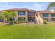 Exterior shot of the house with a landscaped backyard, screened-in patio, and well-maintained lawn at 8103 Bardmoor Pl # 203G, Seminole, FL 33777