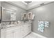Updated bathroom featuring double sinks, granite countertop, and gray walls at 8103 Bardmoor Pl # 203G, Seminole, FL 33777