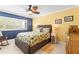 Well lit bedroom with wicker bed and coastal decorations at 8103 Bardmoor Pl # 203G, Seminole, FL 33777