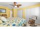 Bright bedroom with yellow walls, ceiling fan, and double closets, offering ample storage at 8103 Bardmoor Pl # 203G, Seminole, FL 33777