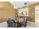Cozy dining area with pass-through to the kitchen and contemporary light fixture at 8103 Bardmoor Pl # 203G, Seminole, FL 33777