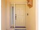 Charming front door with sidelight and decorative hardware, set in a stucco facade at 8103 Bardmoor Pl # 203G, Seminole, FL 33777