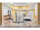 Bright kitchen with stainless steel appliances, granite countertops, white cabinets, and a breakfast bar at 8103 Bardmoor Pl # 203G, Seminole, FL 33777