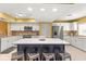 Well-lit kitchen featuring an island with seating, stainless steel appliances, and ample storage at 8103 Bardmoor Pl # 203G, Seminole, FL 33777