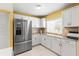 Bright kitchen with stainless steel refrigerator and white cabinetry at 8103 Bardmoor Pl # 203G, Seminole, FL 33777