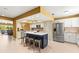 Bright kitchen featuring stainless steel appliances, island with breakfast bar, and modern white cabinetry at 8103 Bardmoor Pl # 203G, Seminole, FL 33777