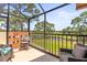 Relaxing screened-in lanai with golf course view and comfortable seating at 8103 Bardmoor Pl # 203G, Seminole, FL 33777