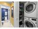 Well-organized laundry room with washer, dryer, and storage shelves at 8103 Bardmoor Pl # 203G, Seminole, FL 33777