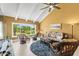 Sunny living room featuring tile floor, comfortable seating, and a beautiful golf course view at 8103 Bardmoor Pl # 203G, Seminole, FL 33777