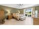 Bedroom featuring neutral walls, tile flooring, and sliding doors to the balcony with golf view at 8103 Bardmoor Pl # 203G, Seminole, FL 33777
