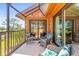 Relaxing screened patio with comfortable seating and stunning golf course views at 8103 Bardmoor Pl # 203G, Seminole, FL 33777