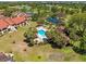Aerial view of the community pool, surrounded by lush landscaping and inviting lounge chairs at 8103 Bardmoor Pl # 203G, Seminole, FL 33777