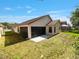 Backyard features a screened in lanai and a grass lawn with privacy fencing at 9200 Halberg Dr, Hudson, FL 34669