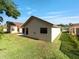 Backyard view reveals a green lawn and mature landscaping offering privacy at 9200 Halberg Dr, Hudson, FL 34669