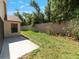 Backyard features a patio area and a privacy wall with mature shrubs and foliage at 9200 Halberg Dr, Hudson, FL 34669
