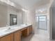 Bathroom features a long countertop with double sinks, tile floor, and vanity lighting at 9200 Halberg Dr, Hudson, FL 34669