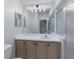 Well-lit bathroom features a vanity with a light wood cabinet and shower with glass doors at 9200 Halberg Dr, Hudson, FL 34669