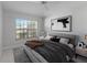 Bright bedroom boasts a large window, ceiling fan, and contemporary decor at 9200 Halberg Dr, Hudson, FL 34669