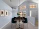 Dining room with a modern table set for dinner, surrounded by bright walls and elegant decor, high ceilings at 9200 Halberg Dr, Hudson, FL 34669