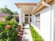 Inviting front entrance with a decorative pillar, lush landscaping, and a walkway leading to the front door at 9200 Halberg Dr, Hudson, FL 34669