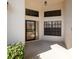 Close-up of front entrance with decorative security door, transom window, and manicured landscaping at 9200 Halberg Dr, Hudson, FL 34669