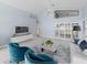 Bright living room featuring a high ceiling, ceiling fan, and large windows with shutters at 9200 Halberg Dr, Hudson, FL 34669