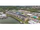 Aerial view of a waterfront community showcasing a complex, tennis courts and a pool at 1 Boca Ciega Point Blvd # 215, St Petersburg, FL 33708
