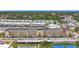 Aerial view showcases a waterfront condo building with boat docks, parking, tennis courts and a pool at 1 Boca Ciega Point Blvd # 215, St Petersburg, FL 33708