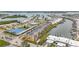 Aerial view of a waterfront community showcasing a complex, tennis courts and a marina at 1 Boca Ciega Point Blvd # 215, St Petersburg, FL 33708