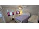 Bright bedroom with white furnishings, two windows with curtains, carpet flooring and a ceiling fan for comfort at 1 Boca Ciega Point Blvd # 215, St Petersburg, FL 33708