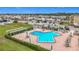 Community pool surrounded by tables, umbrellas, and lounge chairs for a resort-like experience at 1 Boca Ciega Point Blvd # 215, St Petersburg, FL 33708