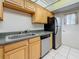 Kitchen featuring tiled floor and a stainless steel refrigerator at 1 Boca Ciega Point Blvd # 215, St Petersburg, FL 33708