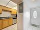Compact kitchen featuring classic cabinets and a tiled floor at 1 Boca Ciega Point Blvd # 215, St Petersburg, FL 33708