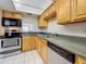 Kitchen with appliances and tiled floors at 1 Boca Ciega Point Blvd # 215, St Petersburg, FL 33708