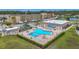 Aerial view of the community pool with a unique shape, surrounded by lush landscaping and lounge chairs at 1 Boca Ciega Point Blvd # 215, St Petersburg, FL 33708
