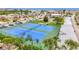 View of tennis courts surrounded by lush greenery and palm trees, adding a tropical feel at 1 Boca Ciega Point Blvd # 215, St Petersburg, FL 33708