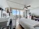 Inviting bedroom with a ceiling fan and a sliding glass door leading to the balcony and water views at 100 Pierce St # 910, Clearwater, FL 33756