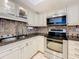 Well-maintained kitchen includes stainless steel appliances, tiled backsplash, and ample cabinetry at 100 Pierce St # 910, Clearwater, FL 33756