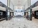 Spacious lobby with marble floors, black marble trim, seating, and elegant lighting at 100 Pierce St # 910, Clearwater, FL 33756