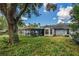 Lush backyard featuring a screened-in patio area perfect for outdoor entertaining and relaxation at 1024 Dockside Dr, Lutz, FL 33559