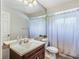 Bathroom featuring a vanity and a shower/tub combo with a white shower curtain at 1024 Dockside Dr, Lutz, FL 33559
