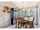 Dining area featuring a wooden table, chairs, and a large window with natural light at 1024 Dockside Dr, Lutz, FL 33559