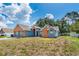 View of the home's side and backyard, showcasing its architectural style and backyard space at 1024 Dockside Dr, Lutz, FL 33559