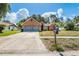 Charming single-Gathering home with a brick facade, two-car garage, and a well-maintained front yard at 1024 Dockside Dr, Lutz, FL 33559