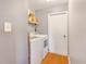 Bright laundry room with washer, dryer, and shelving for storage at 1024 Dockside Dr, Lutz, FL 33559