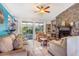 Cozy living room featuring a stone fireplace, tile flooring, and sliding doors to the patio at 1024 Dockside Dr, Lutz, FL 33559