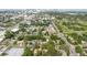 Expansive aerial view of a residential neighborhood featuring tree-lined streets and a golf course in the background at 103 N Meteor Ave, Clearwater, FL 33765