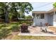 Inviting backyard with a brick patio, chairs, and a fire pit, perfect for outdoor gatherings at 103 N Meteor Ave, Clearwater, FL 33765