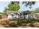 The well-maintained backyard offers a private retreat with a brick patio and lush lawn at 103 N Meteor Ave, Clearwater, FL 33765